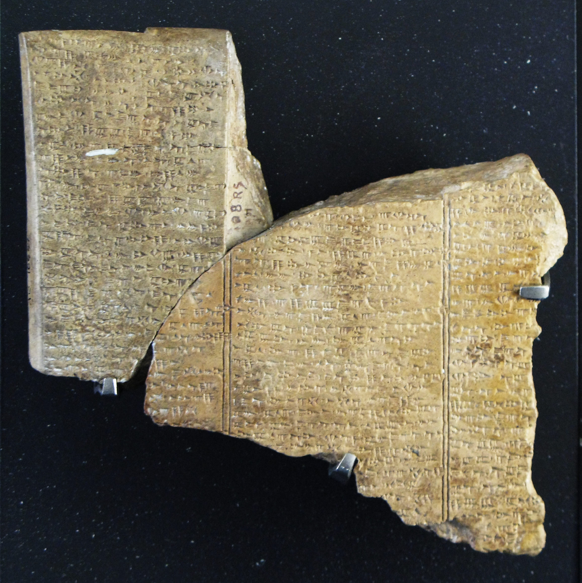 Fragments of Ugaritic KTU 1.5, Louvre AO 16641 and AO 16642, c. 1400–1200 BCE. The Baal Cycle text mentions ltn; the artifact does not depict the creature. Photograph by Rama, 2007, CC BY-SA 2.0 France via Wikimedia Commons; original unchanged
