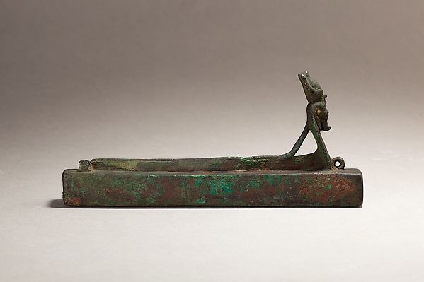 Atum as a human-headed cobra above an animal-mummy box. Made of cupreous metal, the object is dated by the Met to 664–30 BCE; inventory 04.2.519. It illustrates one of the god’s forms in later Egyptian periods