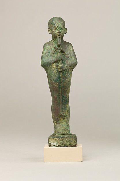 Statuette of Ptah wearing a close-fitting cap, straight beard and enveloping garment. Made of cupreous metal, it is dated by the Met to 664–30 BCE; object 04.2.406