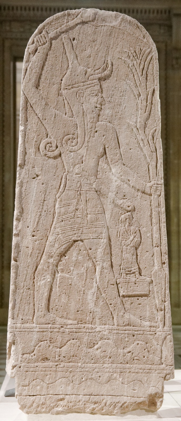 Baal with Thunderbolt stela from Ugarit, limestone, Louvre AO 15775 / RS 4.427. The museum assigns a broad date of 2000–1150 BCE. This depicts Baal, not El, and does not prove that Baal overthrew him